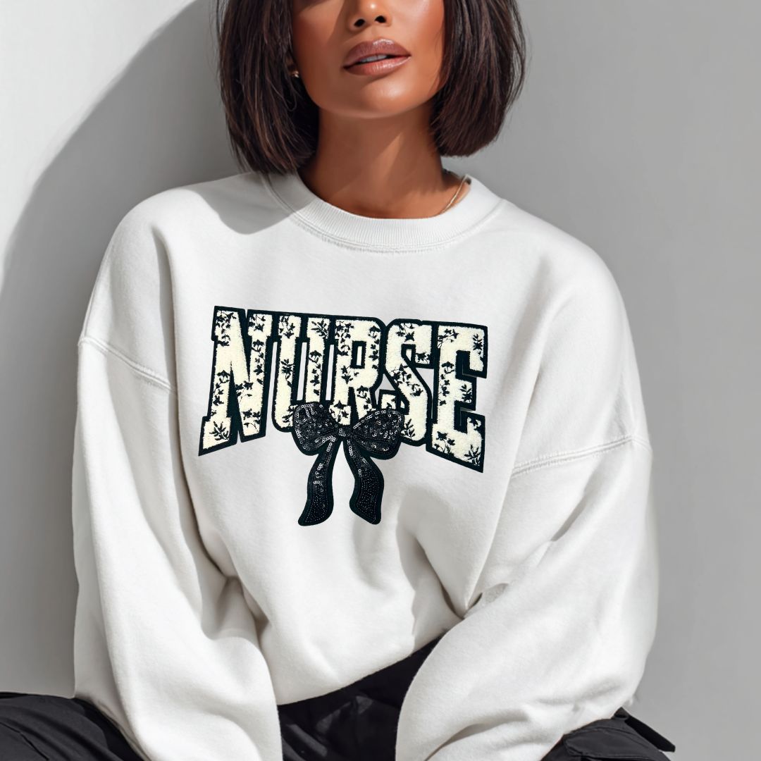 Person wearing a white sweatshirt with &