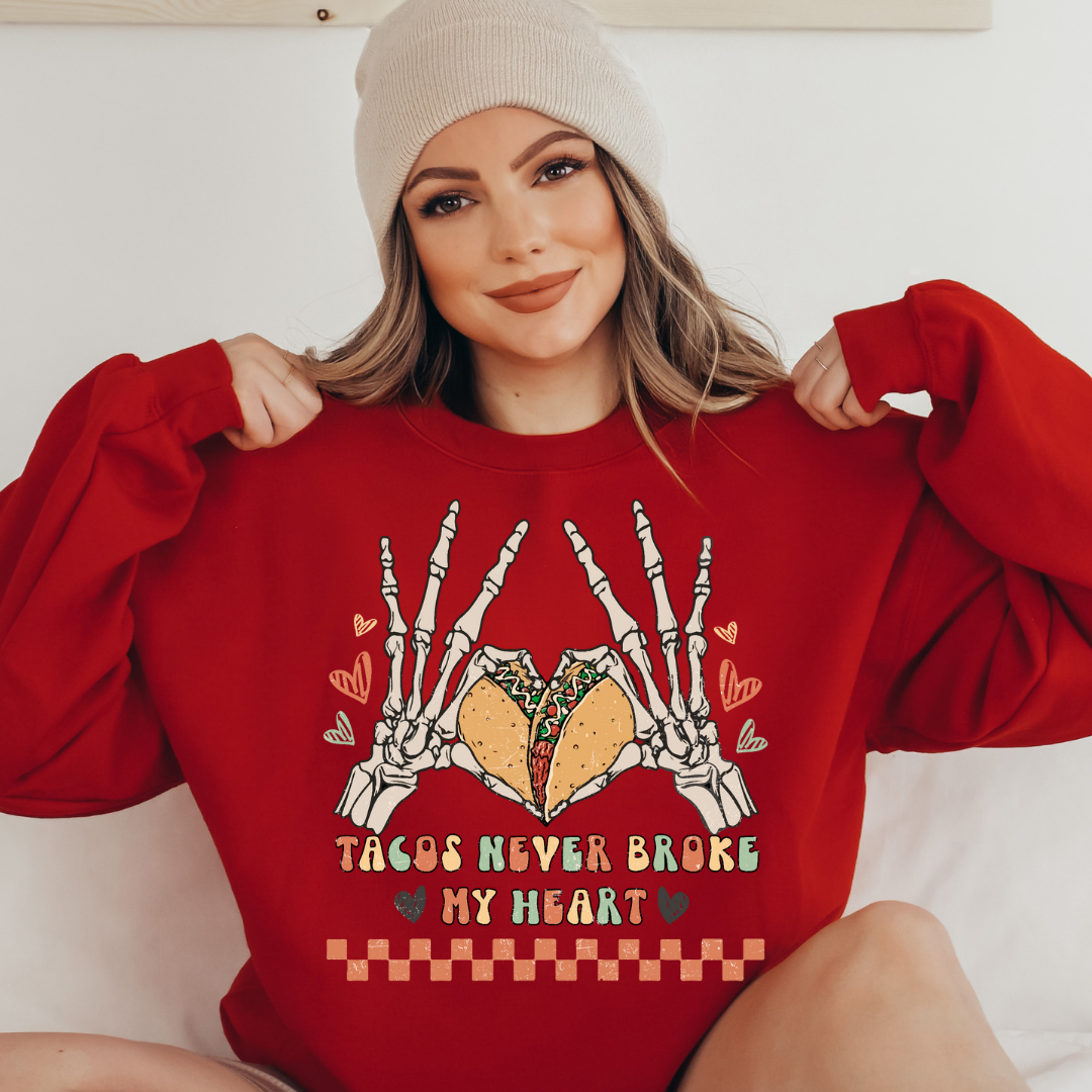 Tacos Never Broke My Heart design printed on soft cotton tee and sweatshirt, featuring motivational graphic tee
