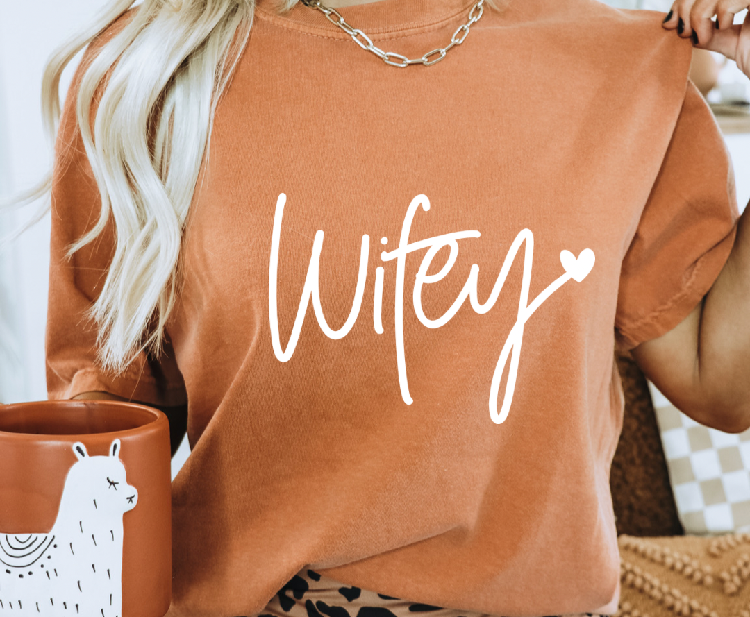 Wifey design printed on soft cotton tee and sweatshirt, featuring motivational graphic tee