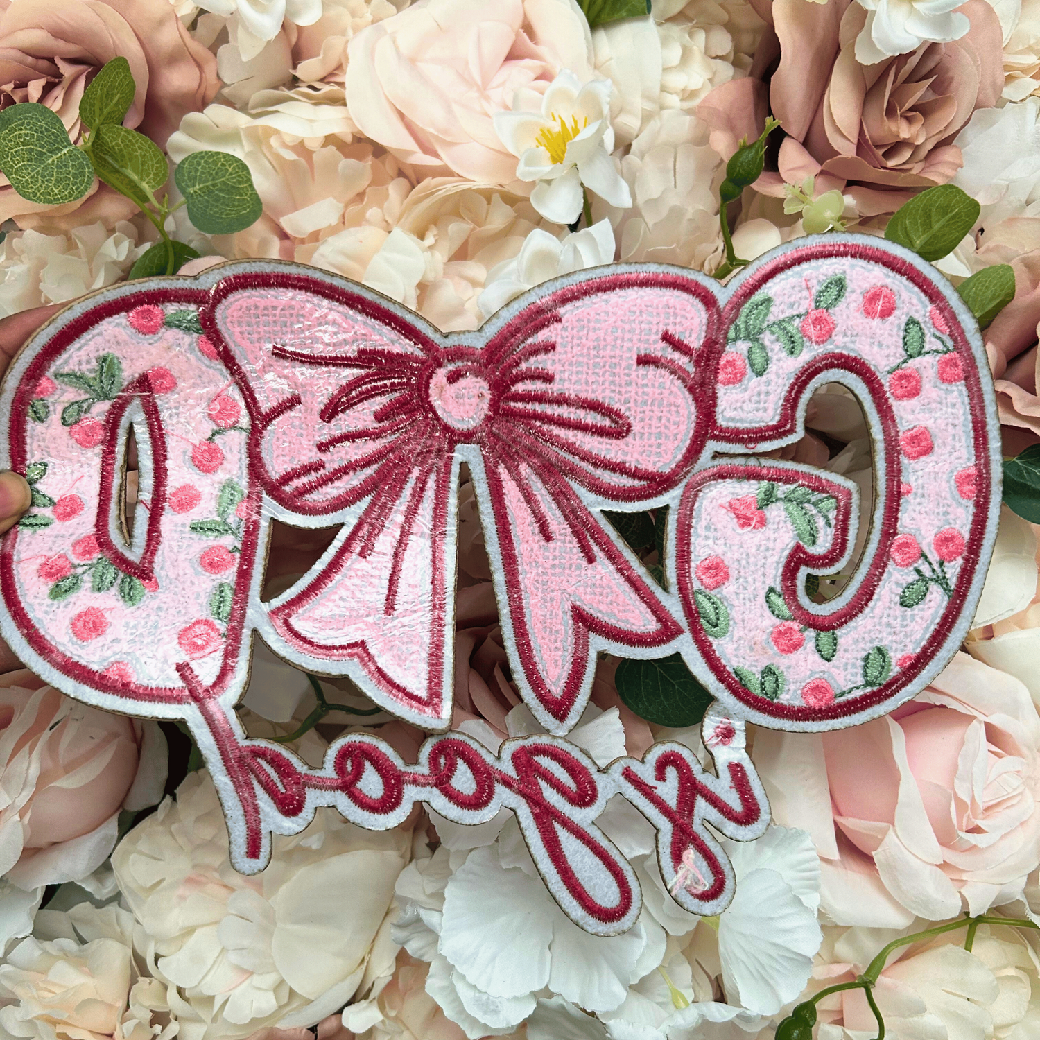 Decorative patch with floral design and text on a floral background