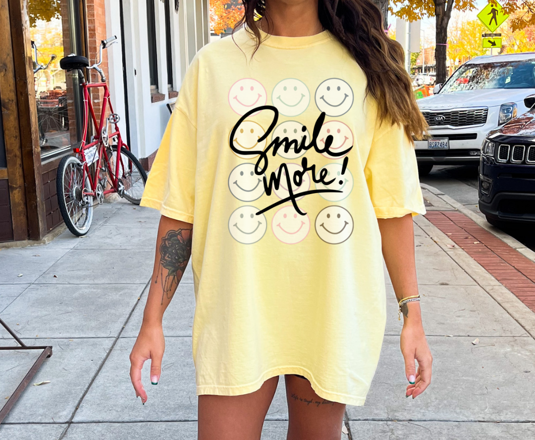 Smile More design printed on soft cotton tee and sweatshirt, featuring motivational graphic tee