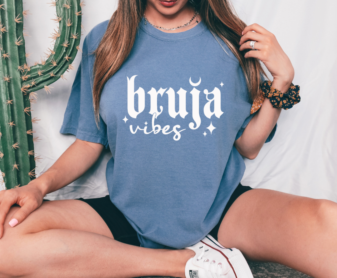 Bruja Vibes design printed on soft cotton tee and sweatshirt, featuring motivational graphic tee