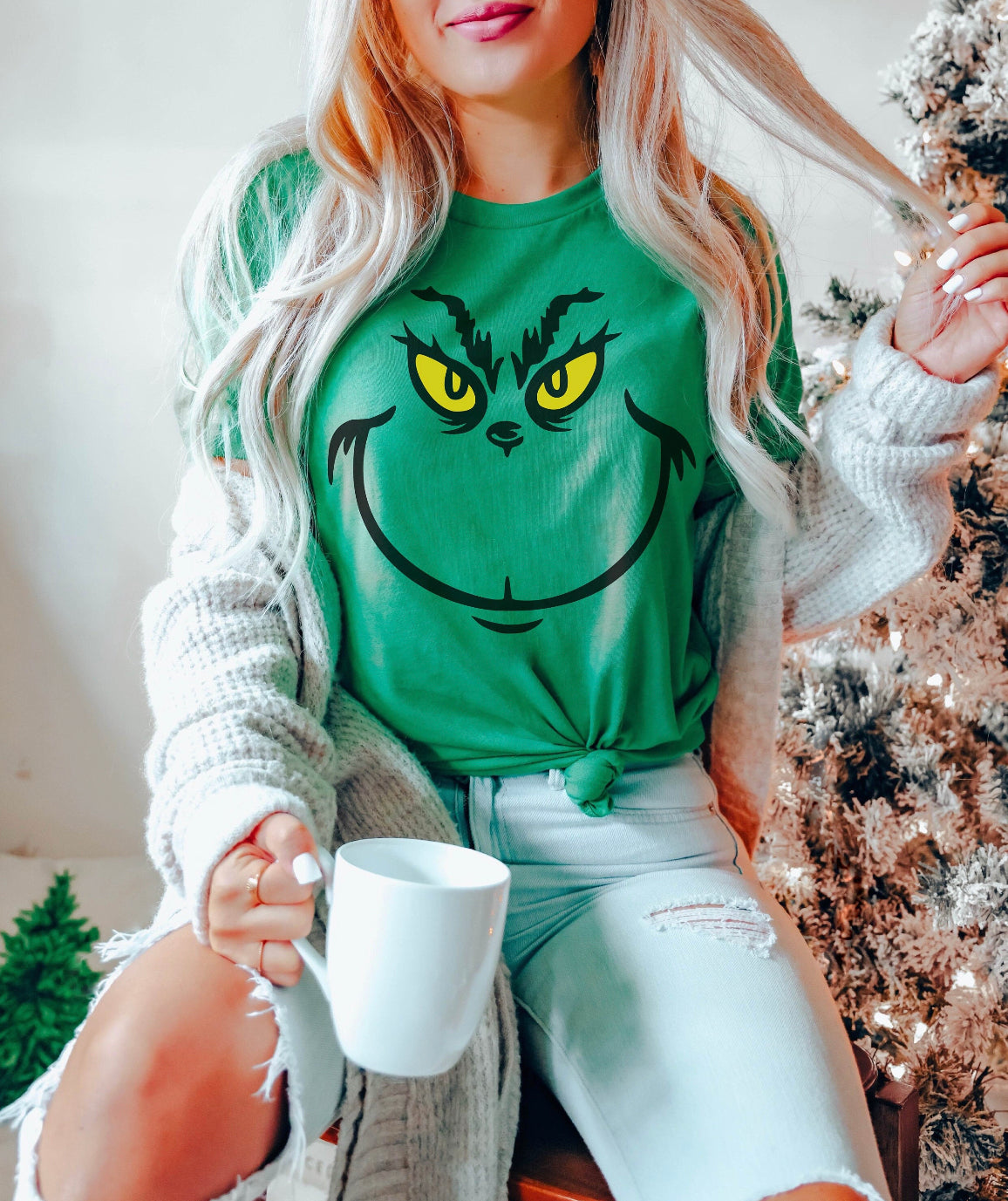 Grinch Face design printed on soft cotton tee and sweatshirt, featuring motivational graphic tee