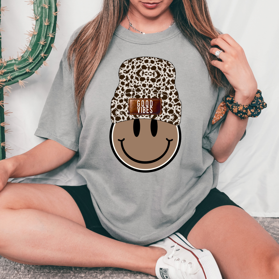 Hooded Smiley Face design printed on soft cotton tee and sweatshirt, featuring motivational graphic tee